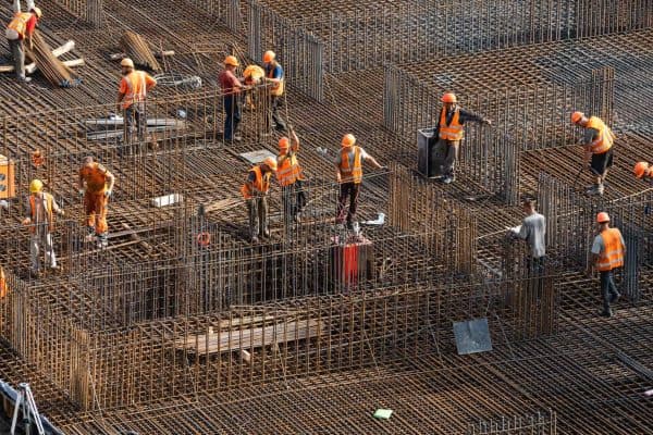 Concrete construction workers on a reinforced foundation